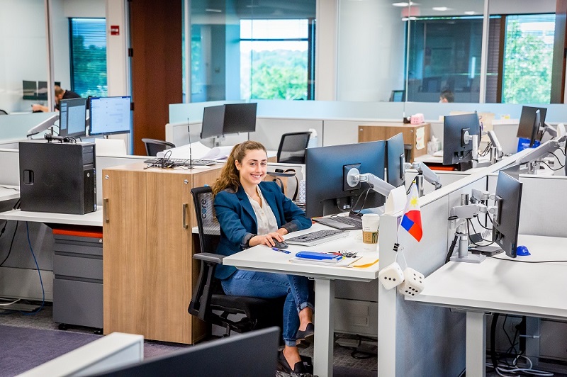 female engineer working at desk smiling