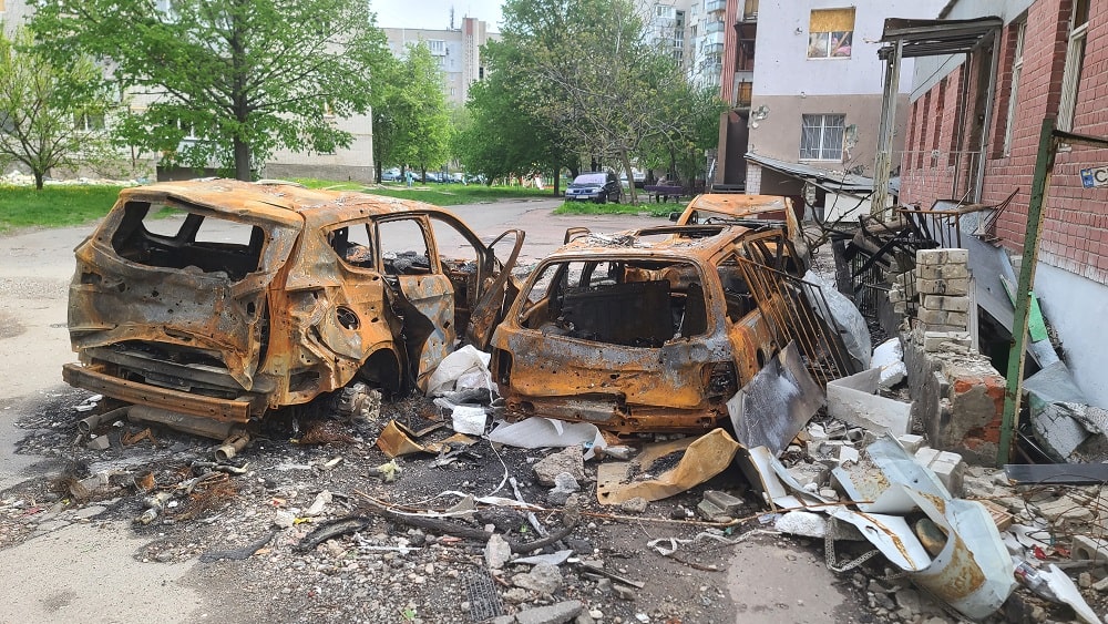 cars and neighborhood that was bombed in the Ukraine